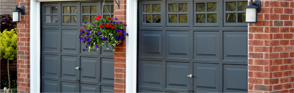 Navy blue garage doors on a brick house