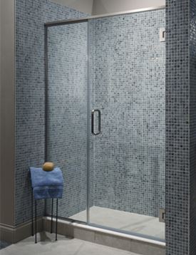 Glass shower door of a blue-tiled walk-in shower.