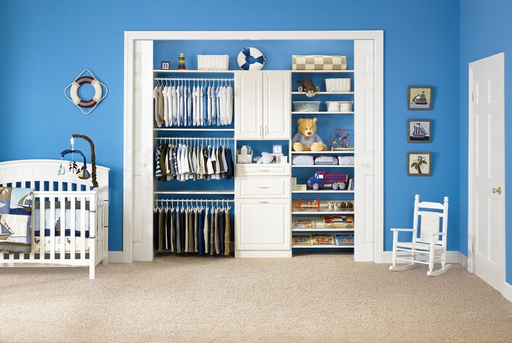 Organized closet shelving in a room with blue walls and white trim