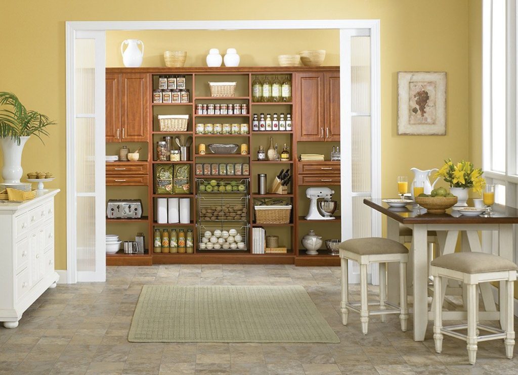 Custom shelving in a pantry off a sunny kitchen.